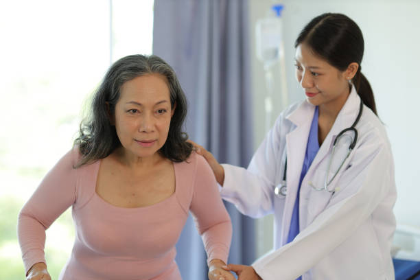 istock Female doctor help a senior patient who is doing physical therapy and is practicing walking with a walking stick. 1716975597