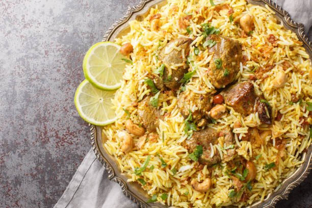 istock Festive pilaf Kacchi Mutton Biryani with nuts, raisins, fried onion closeup on the plate. Horizontal top view 1716976193
