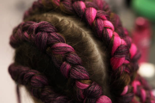 istock Braid the pigtails into a ponytail and an afro-tail 1716976800