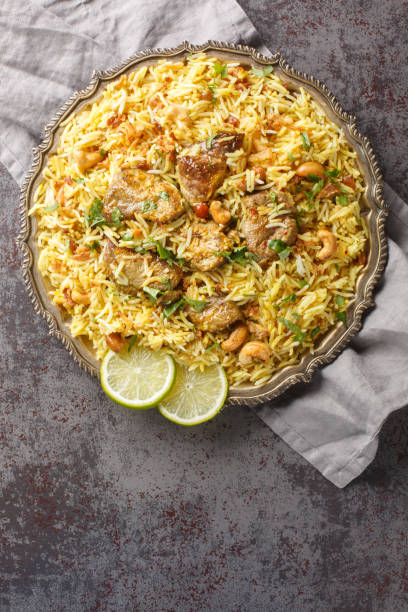 istock Kacchi Mutton Biryani is a delicious rice dish where tender lamb meat pieces are marinated with lots of spicy closeup on the plate. Vertical top view 1716977530