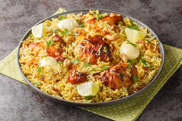 istock Festive pilaf Morog Polao made from chicken and spicy basmati rice with boiled eggs and fried onions closeup on the plate. Horizontal 1716978573