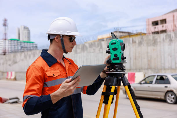 istock Engineer use theodolite equipment and looking blueprints on tablet construction project for route surveying to build a bridge 1716979122