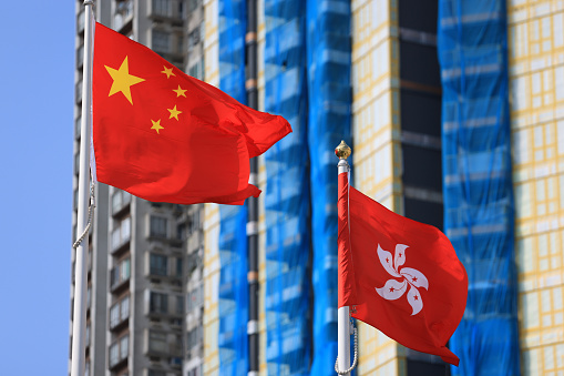 Chinese and hong kong flag set up in the event for celebrating the National Day of the People's Republic of China 74 th anniversary against the real estate background