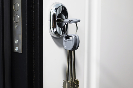 Home Ownership the day you get your new Keys to your new home. House keys inside door lock.