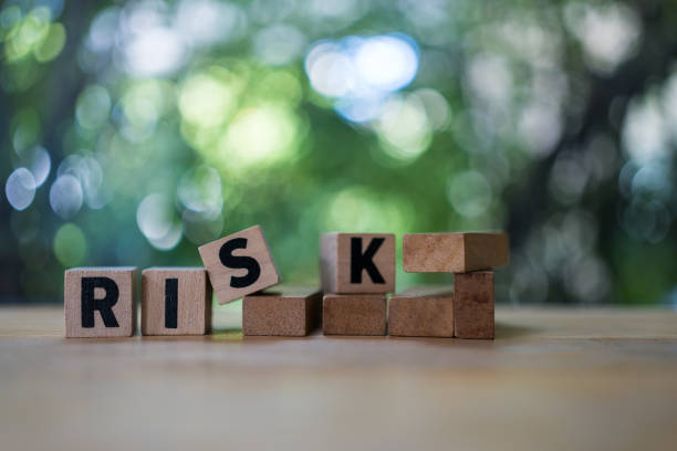 istock Four wood cubes with black letters spelling RISK. Risk Management 1716996558