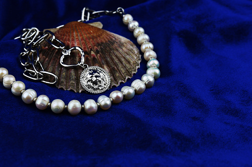 Women's jewelry in the form of natural pearl beads on blue velvet.