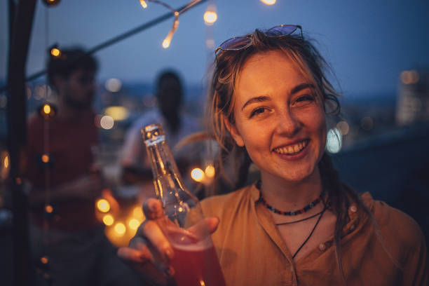 istock Woman on rooftop party 1717007461