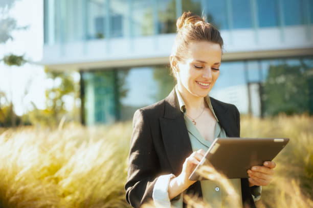 istock happy modern woman worker in business district using tablet PC 1717026778