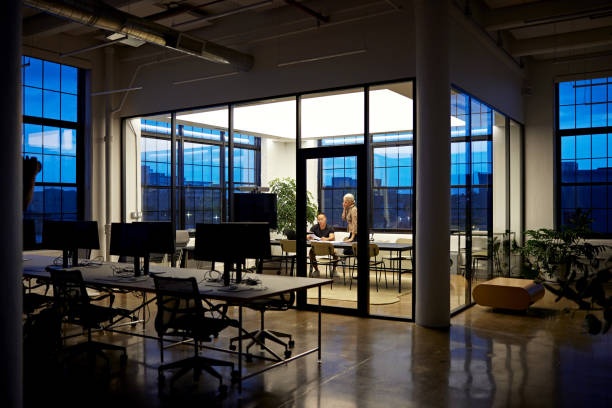 istock Business partners working late in modern loft office 1717027906