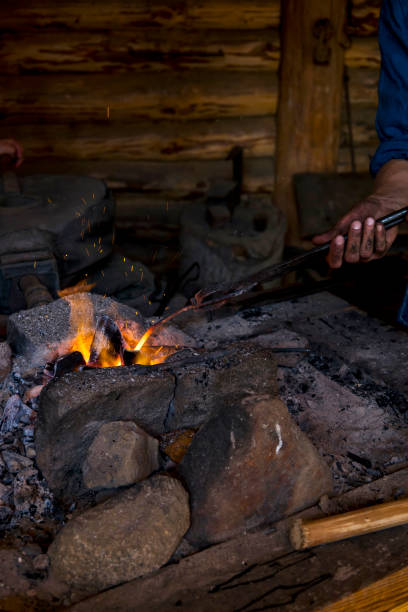 istock Blacksmith working metal with hammer on the anvil in the forge 1717028464