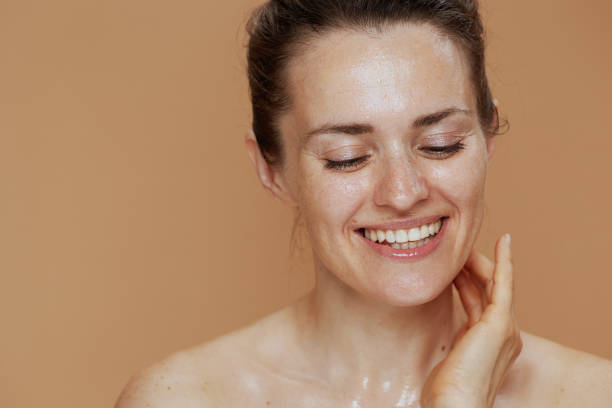 istock happy modern female with wet face washing 1717037762
