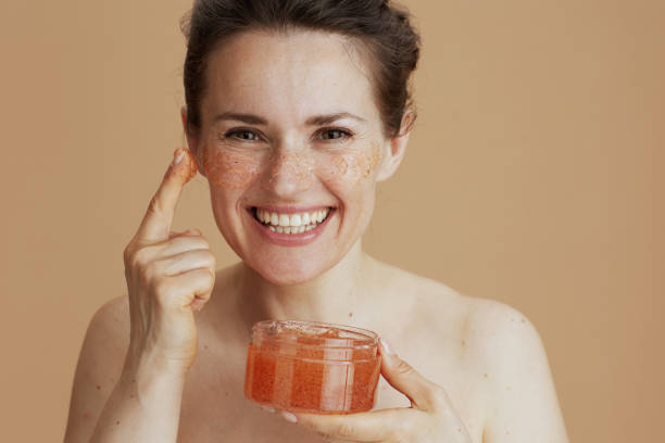 istock smiling modern woman with face scrub 1717037766