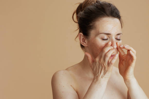 istock modern female with face scrub isolated on beige 1717037768