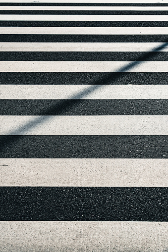Symmetry of monochromatic parallel lines of crosswalk, asphalt rough pattern