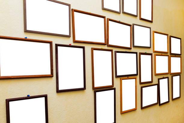 istock Lots of empty little photo frames on the yellow wall 1717042261