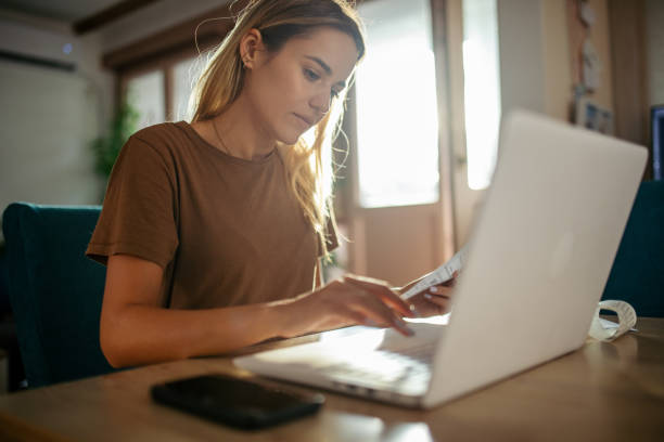 istock Young woman planning budget at home using lap top 1717046946