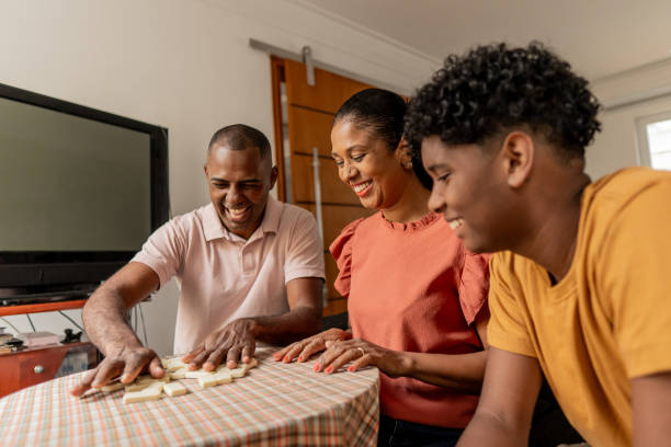 istock Family playing with dominos at home 1717048055
