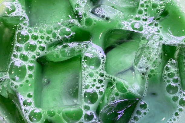 istock Colorful soapy liquid with bubbles closeup, cloudy water texture with transparent ice cubes and bubbles 1717048590