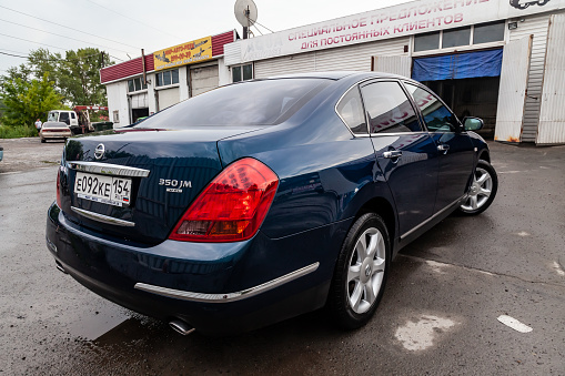 Pavlodar, Kazakhstan - 07.11.2023: Blue Nissan Teana 2007 year rear view with dark black interior in excellent condition on the parking