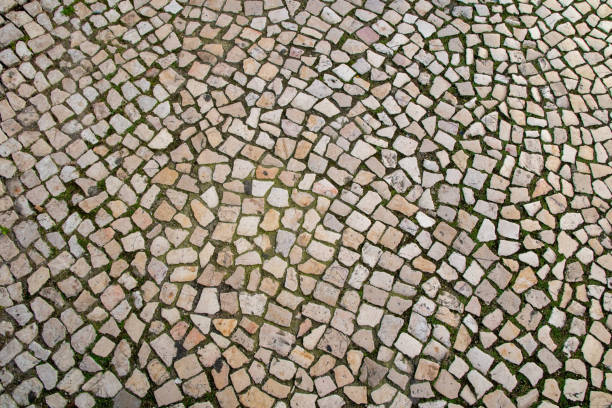 istock Paved pavement close up, granite cobblestoned pavement background, abstract stone pavement texture 1717054384