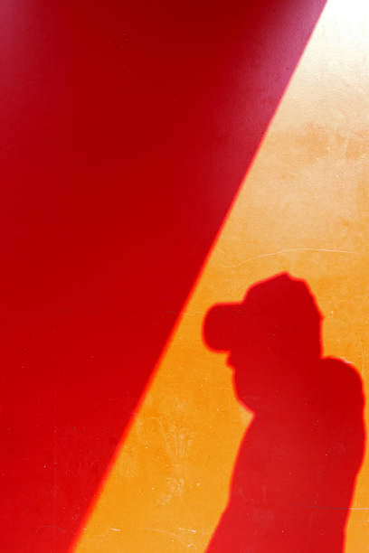 istock shadow of a man on the red painted wall 1717060606