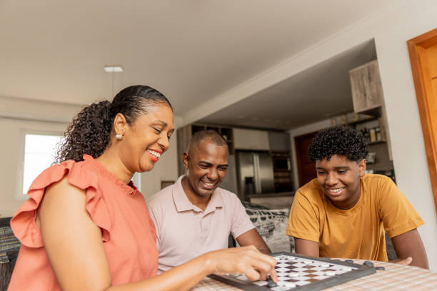 istock Family playing checkers at home 1717062818