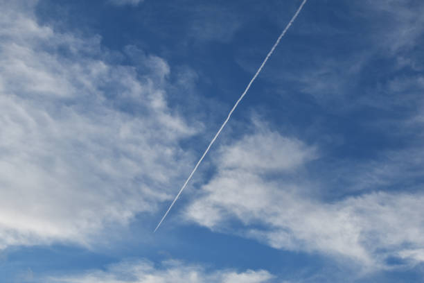 istock Blue sky with white clouds and trace of the plane 1717065613