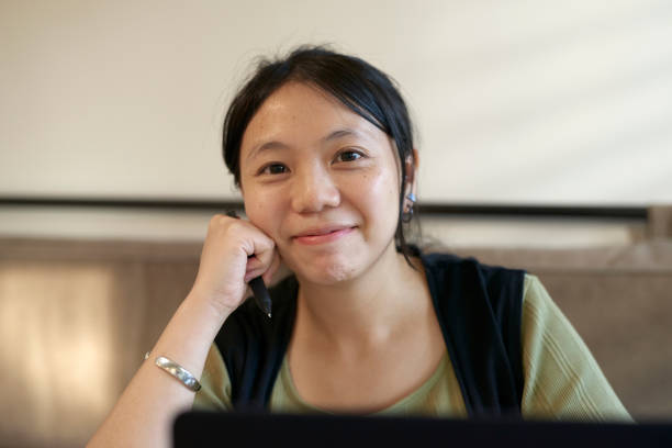 istock Asia young woman using computer working and talking on conference call. 1717073108