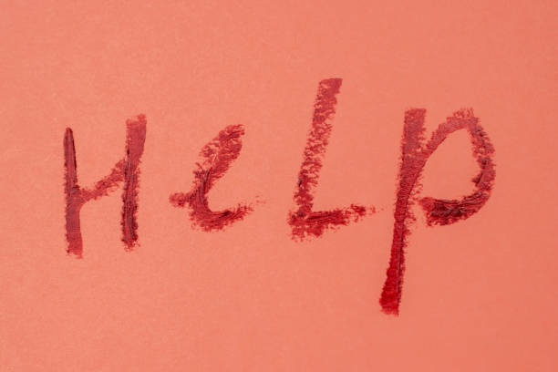 istock Help - red lipstick lettering on salmon pink background 1717073633