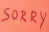 Sorry - red lipstick lettering on pink