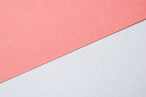 istock Salmon pink and white cardboard texture, colored paper background 1717075785
