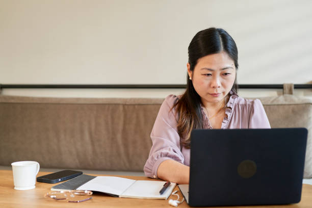 istock Asia young woman using computer working and talking on conference call. 1717076071