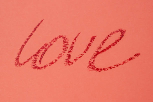 istock Love - red lipstick lettering on pink 1717076946