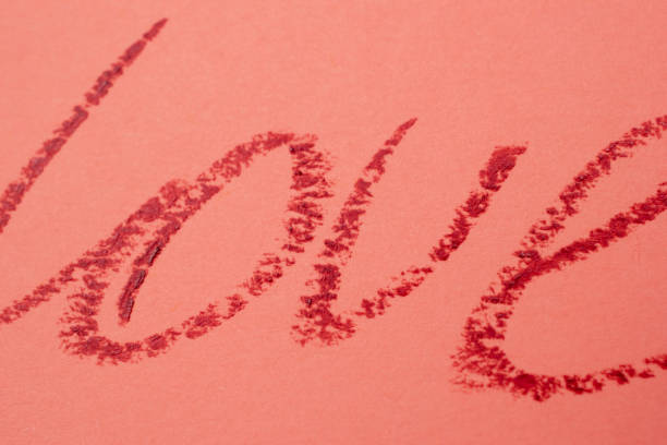 istock Love - red lipstick lettering on pink 1717076949