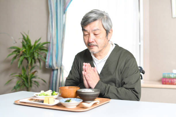 istock Elderly Asian man smiling and eating indoors 1717081334