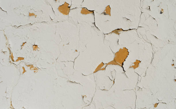 istock Texture of a concrete old wall with stains and cracks, white peeling paint background 1717111518