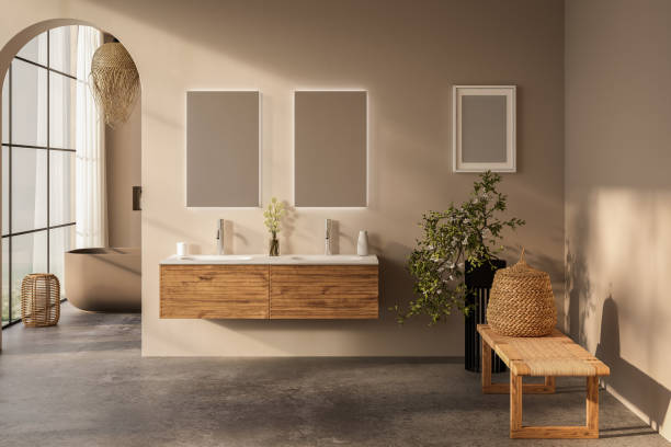 istock Beige bathroom interior with white basin and double mirror, concrete floor, bathtub, plants. Bathing accessories and window in hotel studio. 1717117209