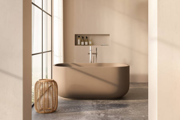 istock Beige bathroom interior with white basin and double mirror, concrete floor, bathtub, plants. Bathing accessories and window in hotel studio. 1717117211