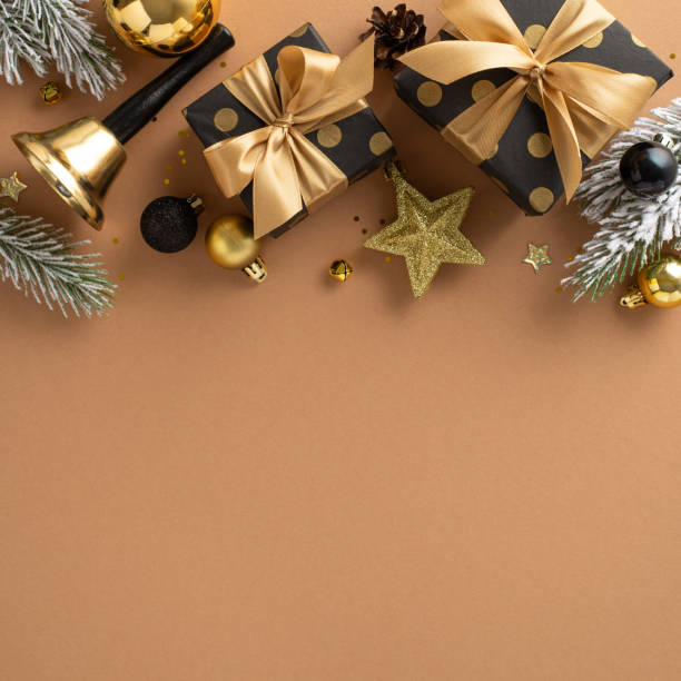 istock Dive into joy of Christmas with this captivating square arrangement. Top-view vertical image of stylishly packaged gifts, lavish black, gold balls, star, shiny confetti, bell, frosty fir twigs on terracotta 1717118485