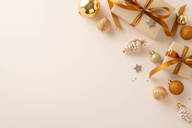 istock Welcome New Year with festive touch! Top-view handmade gift boxes, holiday balls, pine cone-shaped embellishments, shimmering stars and sequins on neutral backdrop, ready for your custom greeting 1717119052