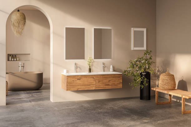 istock Beige bathroom interior with white basin and double mirror, concrete floor, bathtub, plants. Bathing accessories and window in hotel studio. 1717119697