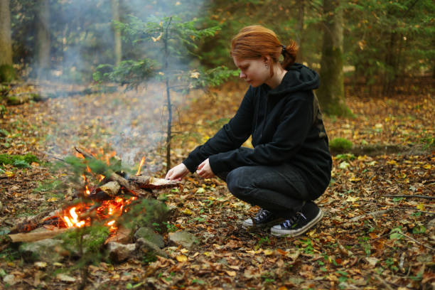 istock a girl warms her hands by the fire 1717120375