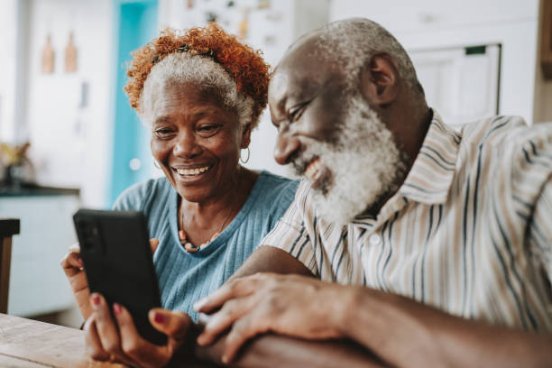 istock Portrait senior couple using smartphone at home 1717120899