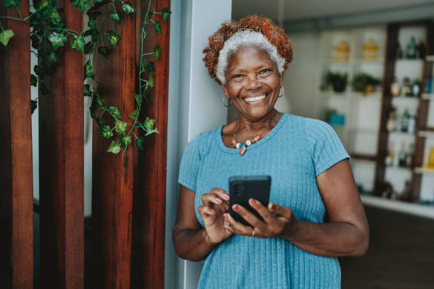 Portrait senior woman using smartphone smiling
