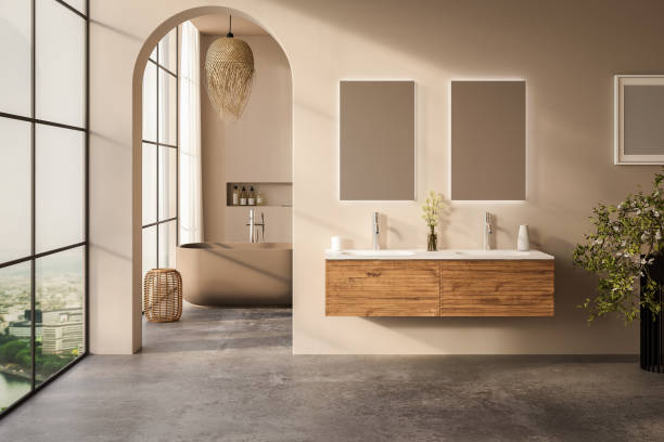 istock Beige bathroom interior with white basin and double mirror, concrete floor, bathtub, plants. Bathing accessories and window in hotel studio. 1717126980
