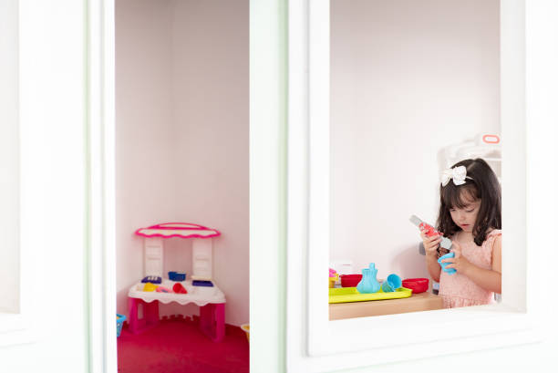 Child playing in the kitchen toy