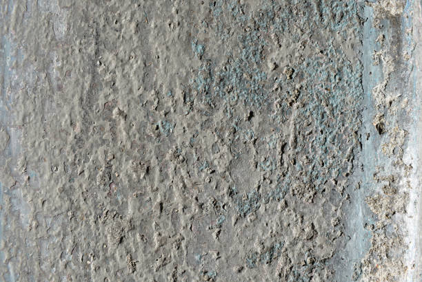 istock Dusty peeling paint wall background, texture of a concrete old wall with stains and cracks 1717143027