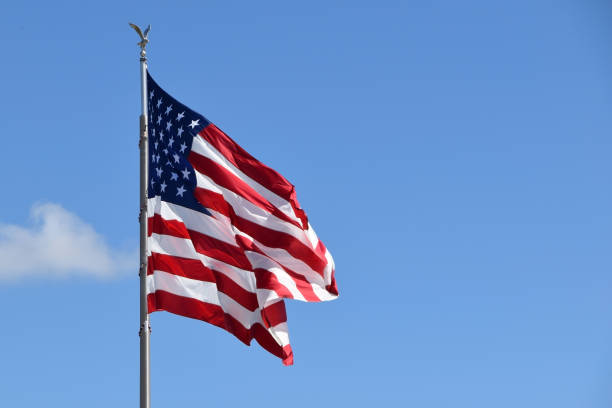 istock USA flag on blue sky background 1717148623