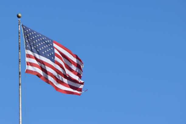 istock USA flag on blue sky background 1717149206