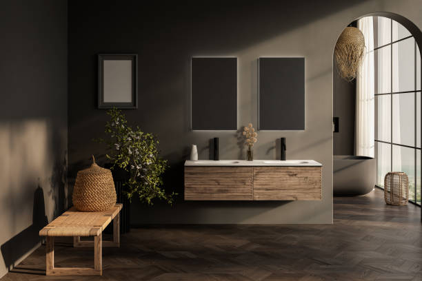 istock Stylish gray bathroom interior with parquet floor, window with mountain view, dark wall, big bathtub, and white basin with vertical mirrors and wooden vanity. 1717154482